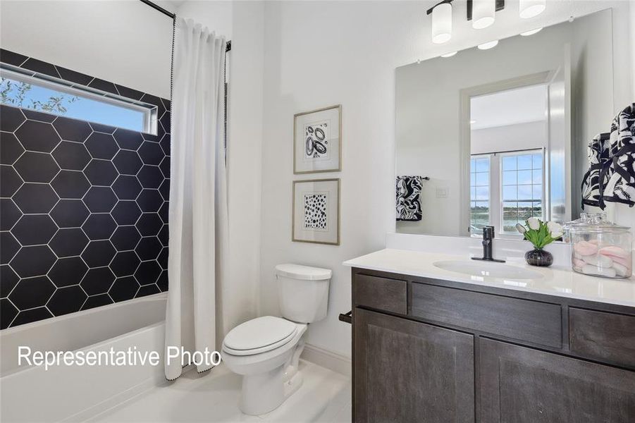 Bathroom featuring a white tub, black hexagonal wall tile, and a rectangular window