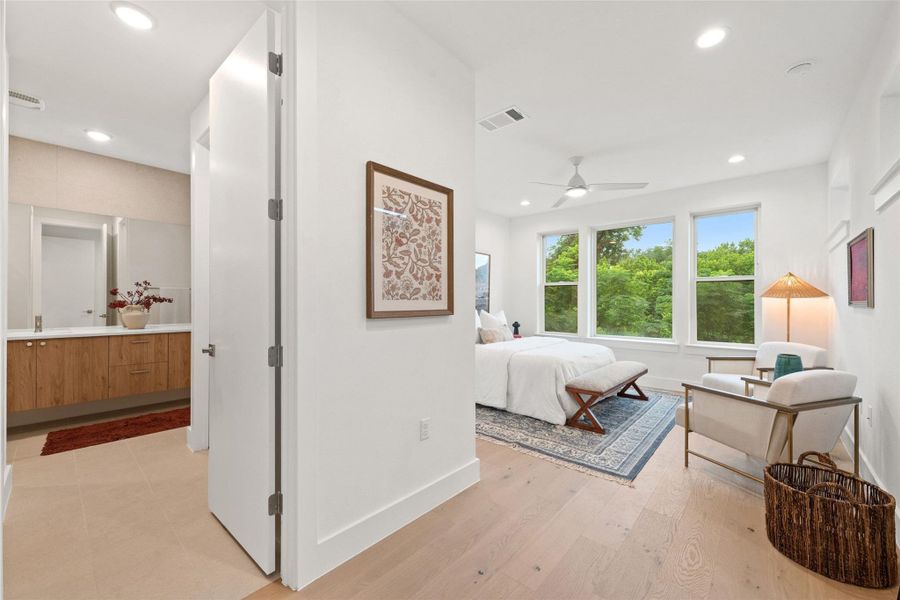 A tranquil primary bedroom suite, offering a seamless transition to a modern, well-appointed bathroom. A tranquil primary bedroom suite, offering a seamless transition to a modern, well-appointed bathroom.