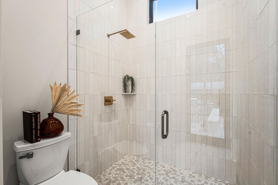 Bathroom with a stall shower and toilet