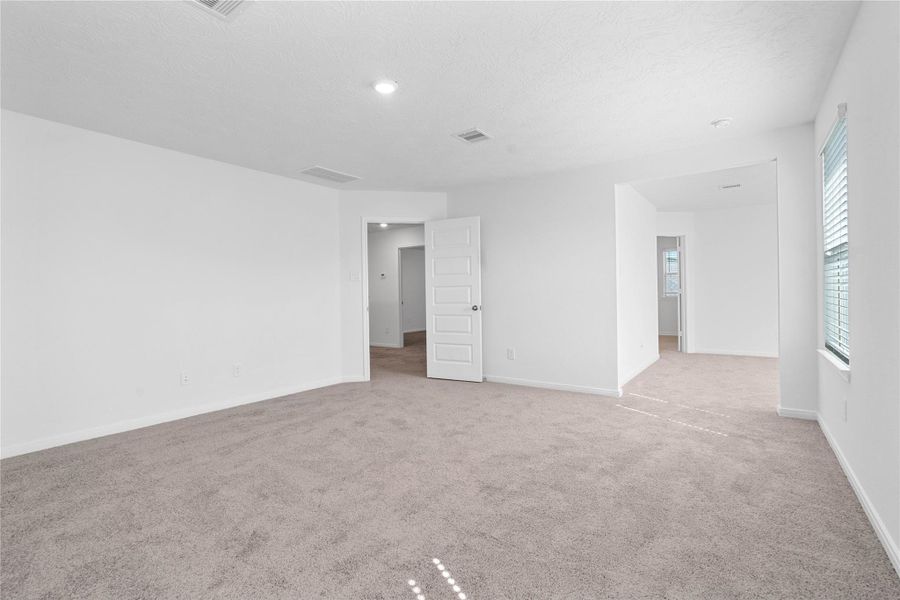 Another view from the primary bedroom looking to the sitting area that leads to the primary bathroom.