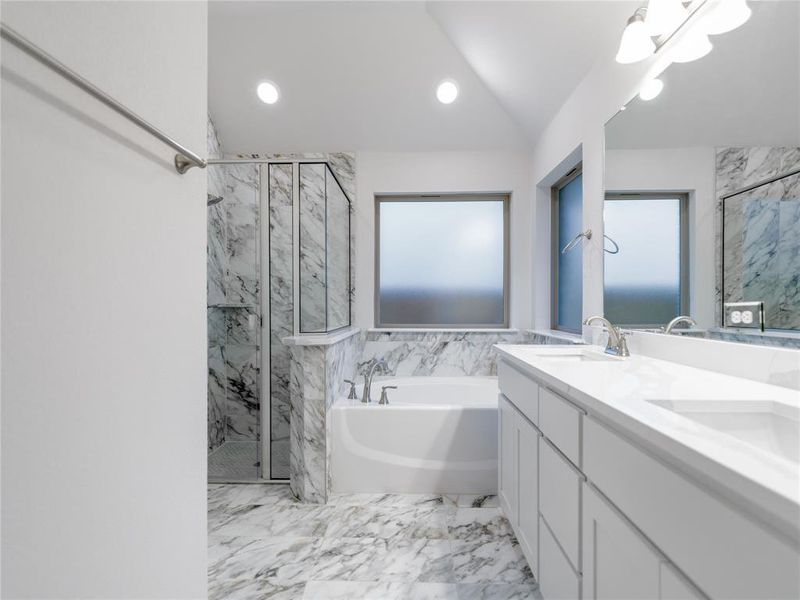 Bathroom with a chandelier, lofted ceiling, vanity, and independent shower and bath