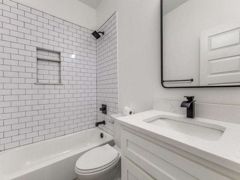 Full bathroom featuring vanity, toilet, and bathtub / shower combination
