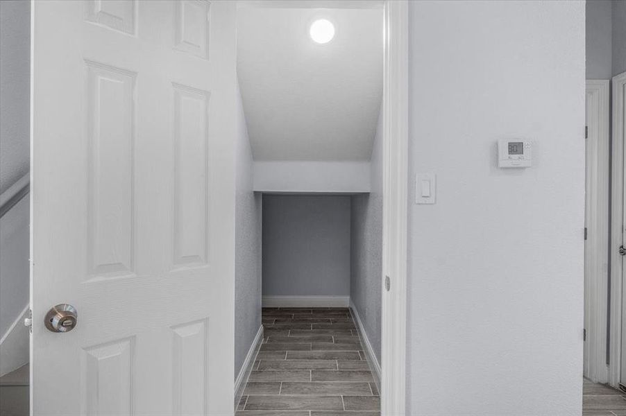 Corridor featuring wood finished floors