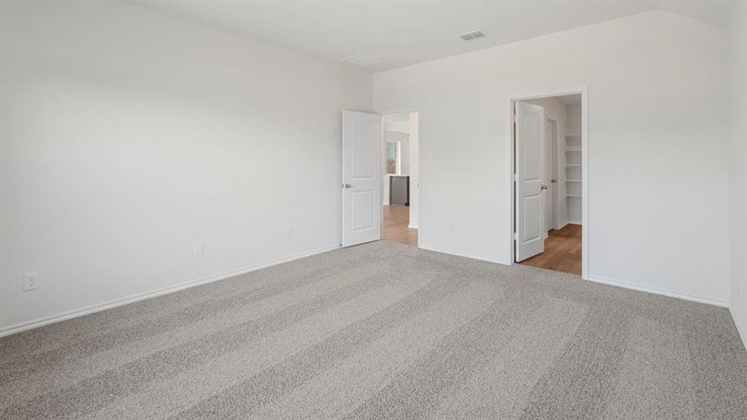 Spacious room with light gray patterned carpet