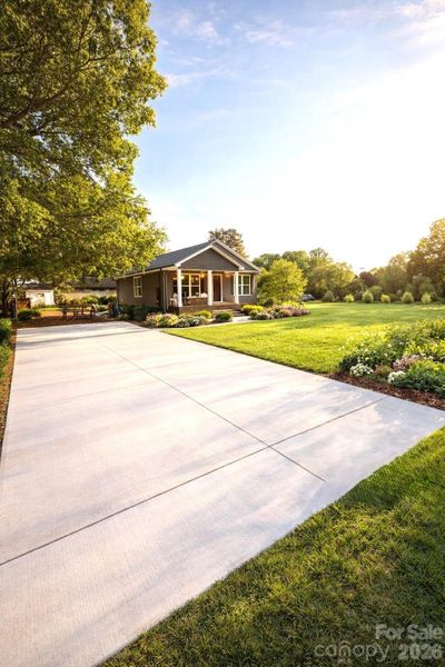 Huge double driveway. Grass has been planted. Virtually staged to show how it will look when grass comes in.