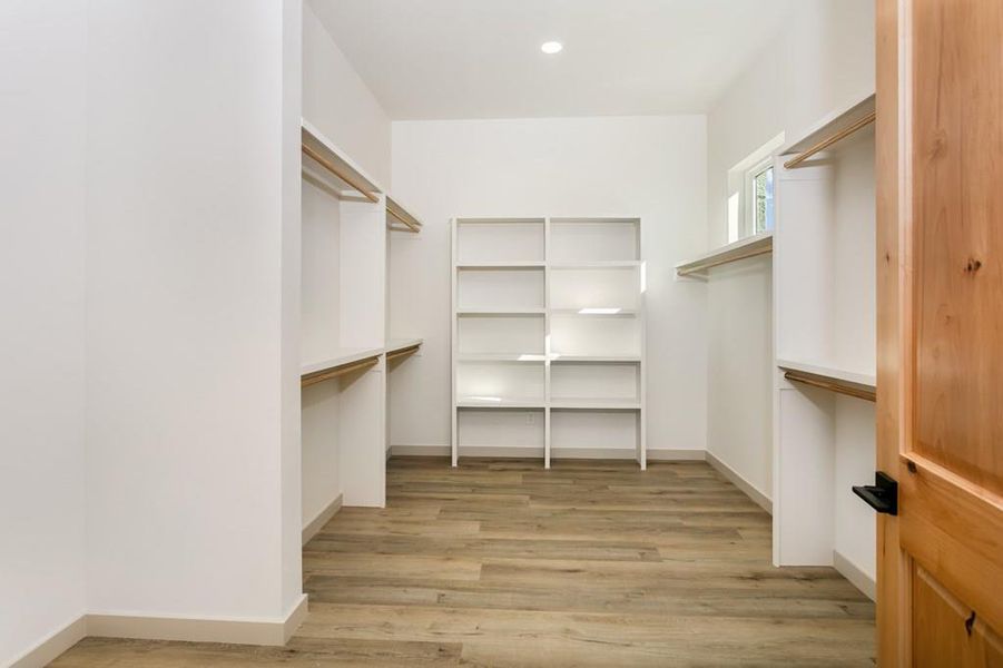 Spacious closet featuring light wood-style floors Spacious closet featuring light wood-style floors