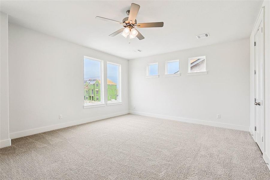 Spare room with ceiling fan and light carpet