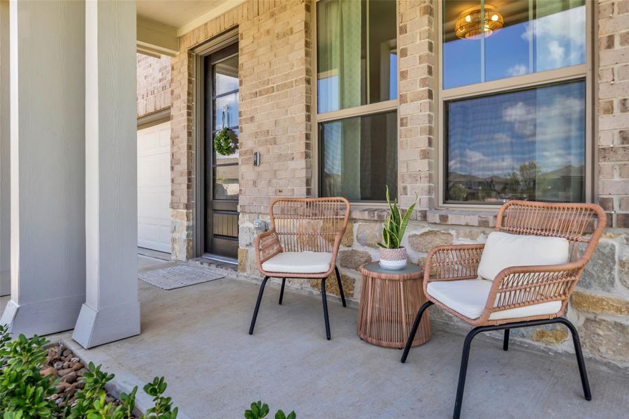 The covered patio at the back of the home provides a comfortable outdoor space to unwind, enjoy the backyard views, and spend time outdoors after a long day.