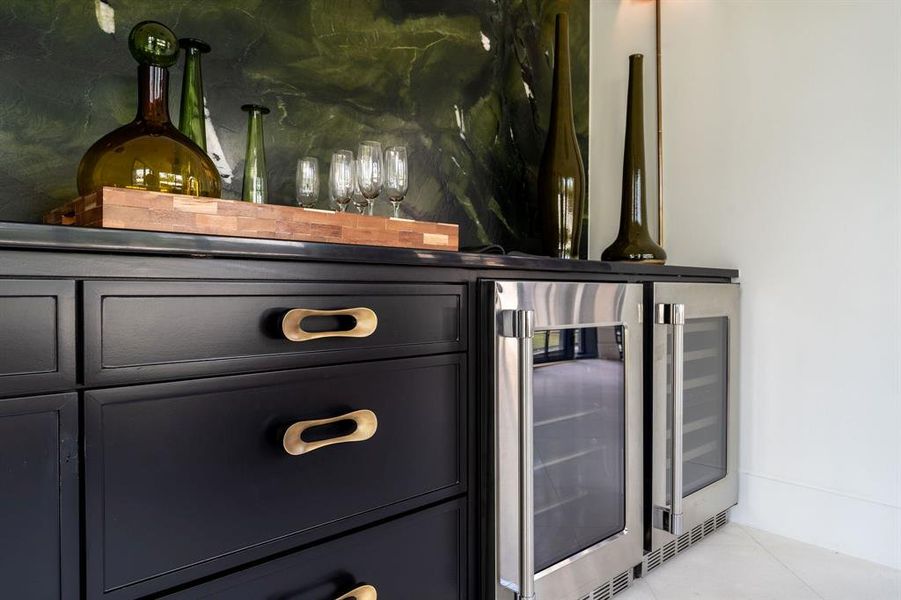 Indoor dry bar featuring beverage cooler and tile patterned floors