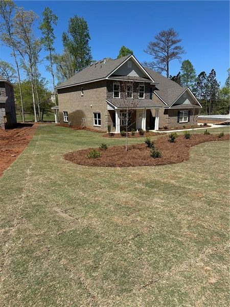 Front exterior of a new home in Mirror Lake at South Harbour, Villa Rica, GA, highlighting curb appeal (Image 17).