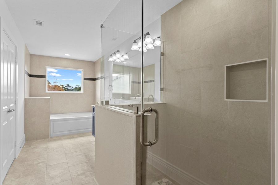 Escape to your spa bathroom retreat!  Gorgeous large tile floors!  What a beautiful bathroom for that primary suite!