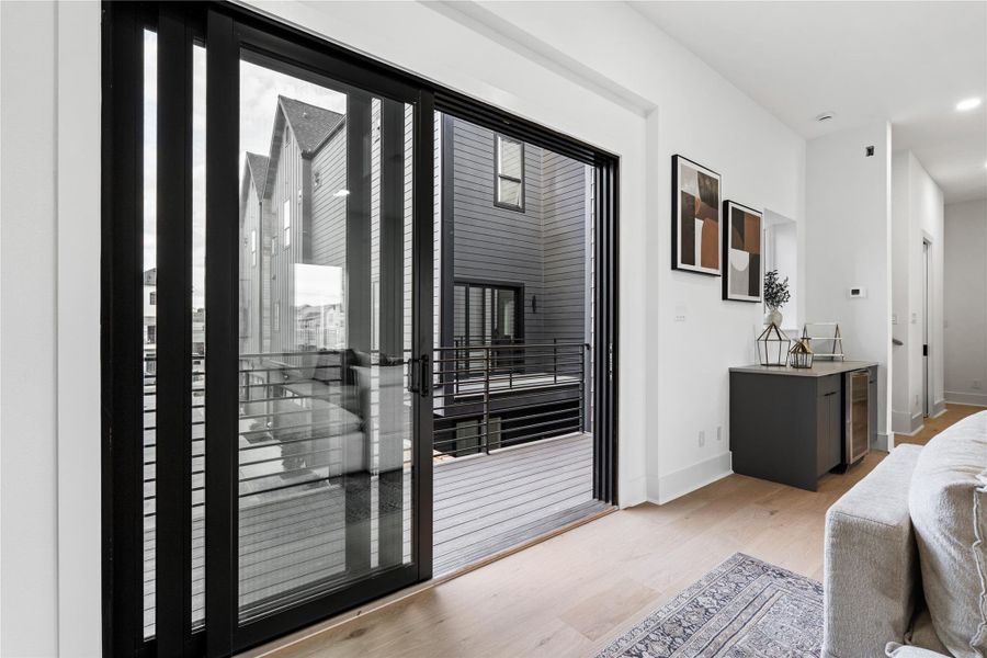 An elevated sleeping sanctuary that balances modern restraint with soft, inviting textures. The vaulted ceiling amplifies the sense of volume, while the private balcony offers a daily ritual of fresh air and quiet moments beyond the glass.