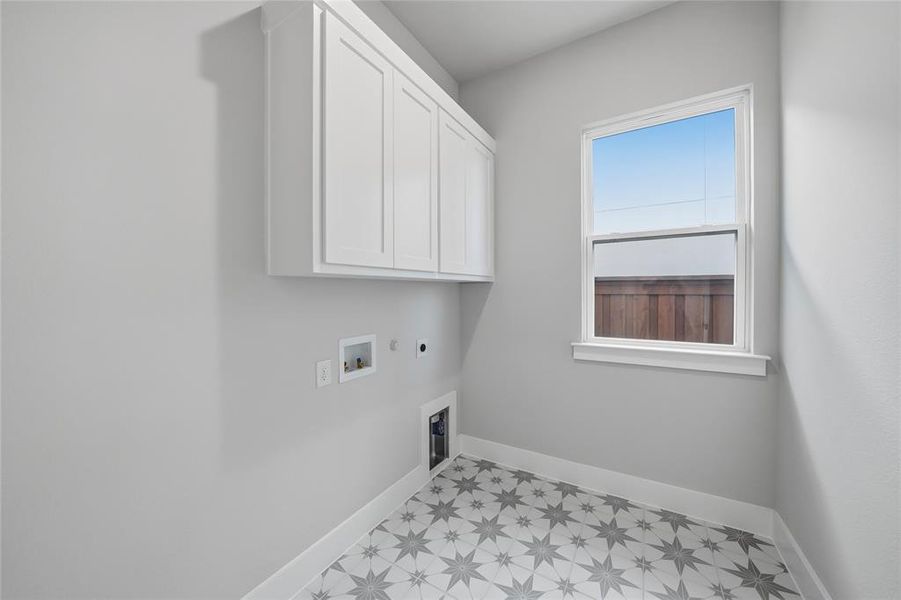 Laundry area with electric dryer hookup, gas dryer hookup, washer hookup, cabinet space, and light flooring