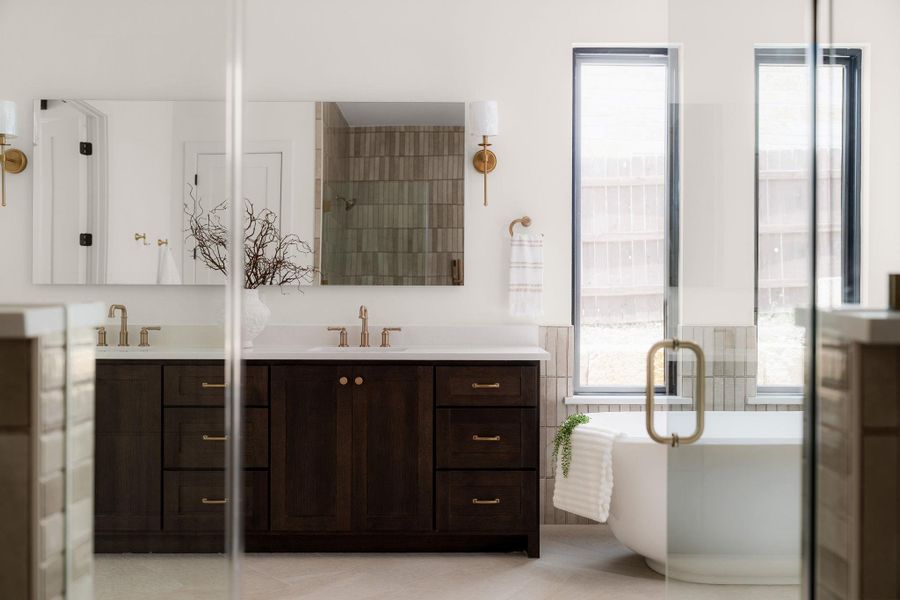 Dual vanities and a freestanding tub create a spa-like retreat in this well-appointed bathroom.