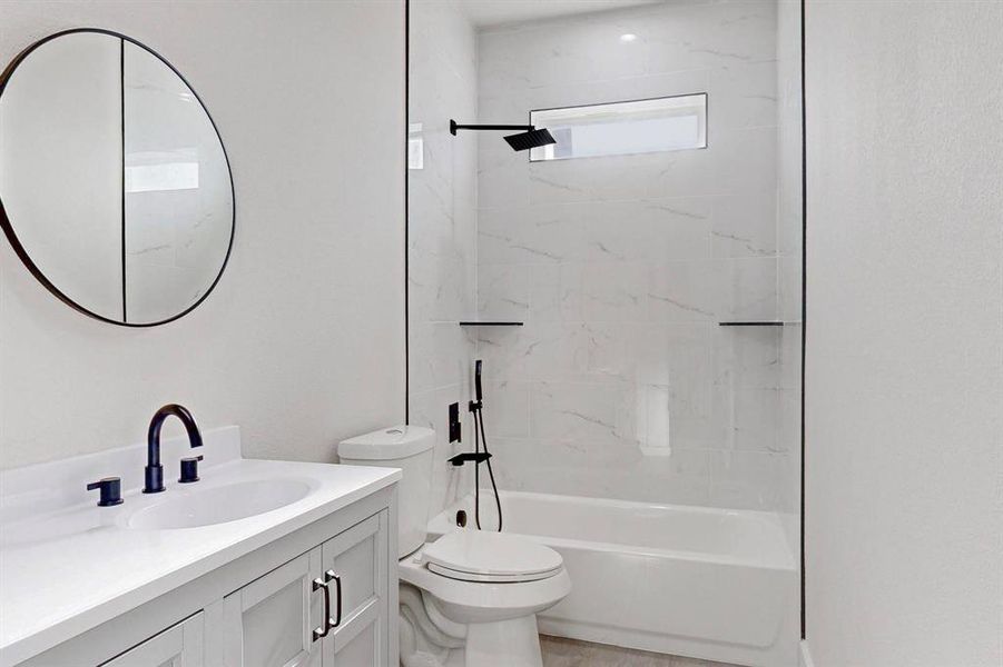 Full bathroom featuring vanity and shower / washtub combination Full bathroom featuring vanity and shower / washtub combination