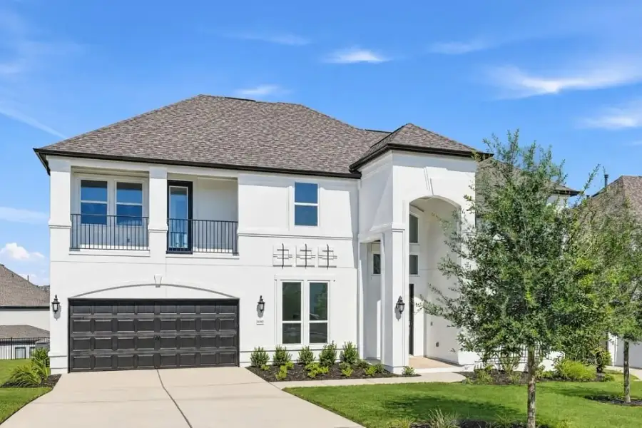 Front exterior of a new home in Travisso, Leander, TX, highlighting curb appeal (Image 1). Front exterior of a new home in Travisso, Leander, TX, highlighting curb appeal (Image 1).
