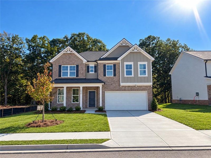 Front exterior of a new home in Kingsmere Estates, Loganville, GA, highlighting curb appeal (Image 22).