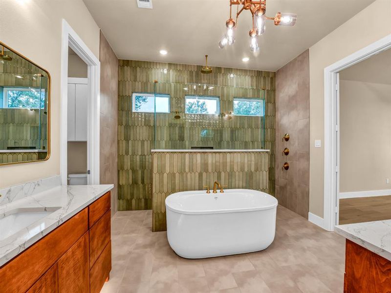 Bathroom with tile patterned flooring, separate shower and tub, a chandelier, vanity, and tile walls