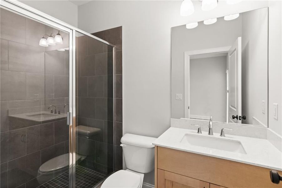 Walk-in shower is perfect for any guest! Not actual home. Photo of previously built Grayton floorplan.