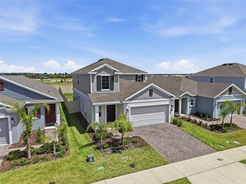 Front exterior of a new home in Wellness Ridge, Clermont, FL, highlighting curb appeal (Image 27).