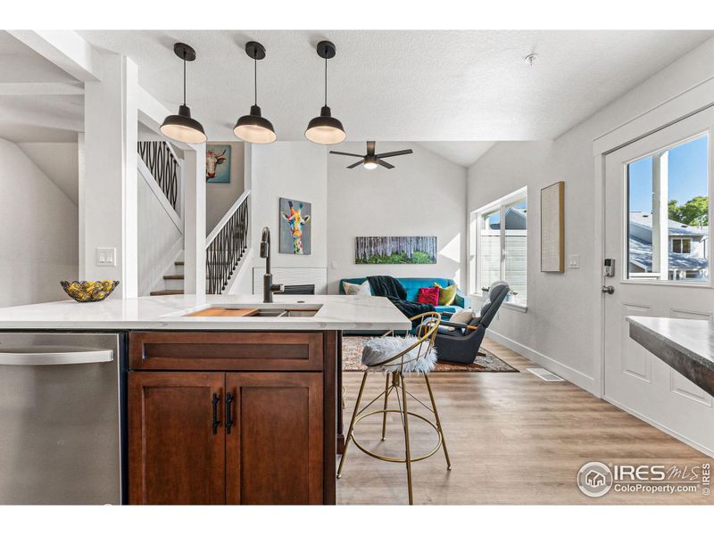 The open floor plan is washed in natural light from the multiple large windows.