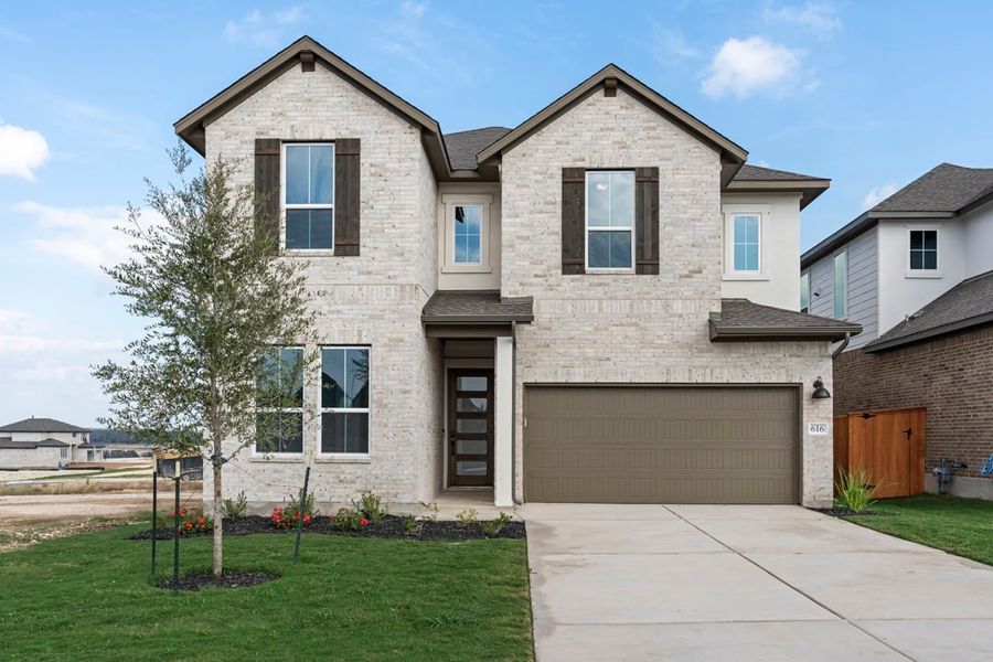 Front exterior of a new home in Arbor Collection at Lariat, Liberty Hill, TX, highlighting curb appeal (Image 2). Front exterior of a new home in Arbor Collection at Lariat, Liberty Hill, TX, highlighting curb appeal (Image 2).