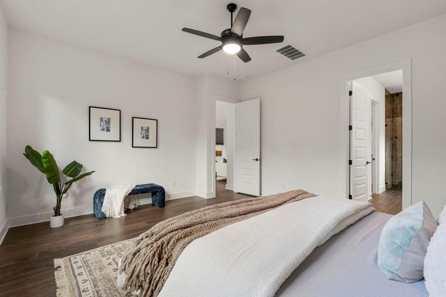 An inviting bedroom with rich hardwood floors, offering a serene escape.