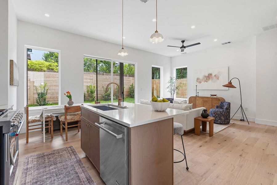 Open-concept living area featuring light wood-finish flooring