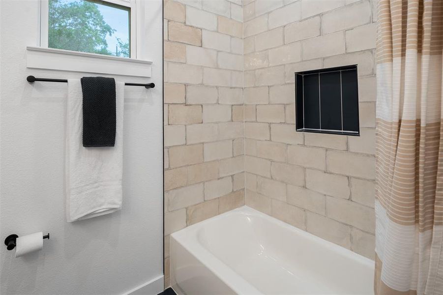 Hall bath with tub/shower combo and beautiful tile. Hall bath with tub/shower combo and beautiful tile.