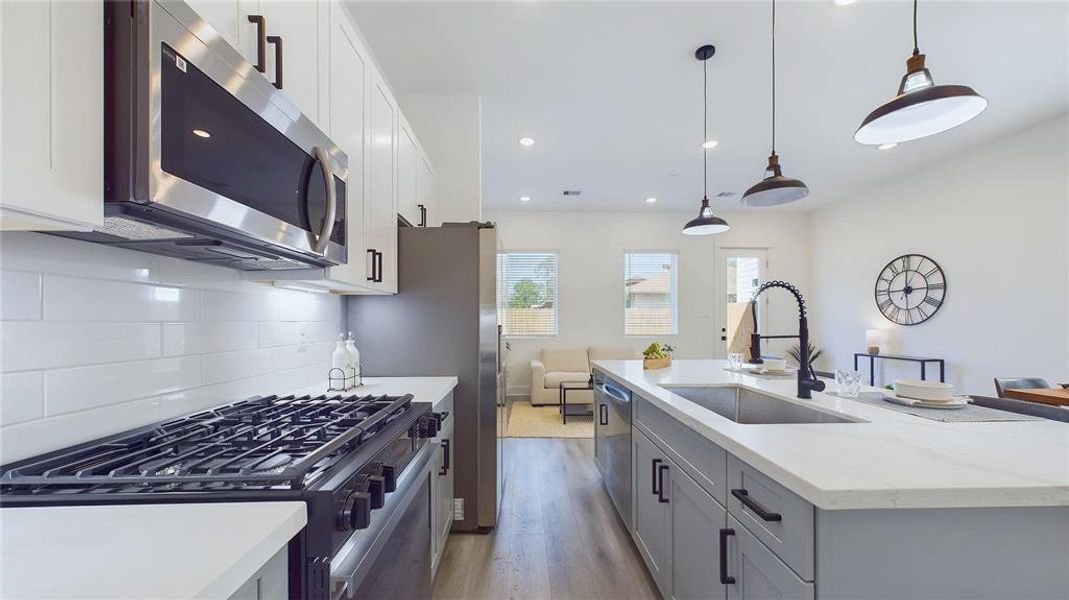 This attractive kitchen is full of beautiful details. Quartz Countertops, stainless sink, stainless steel appliances, recessed lighting, undercabinet lighting, Walk-in-Pantry, elegant cabinetry with soft close drawers and doors