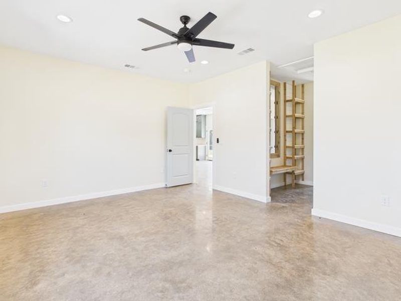 Before photo finished concrete floors, a ceiling fan, and recessed lighting