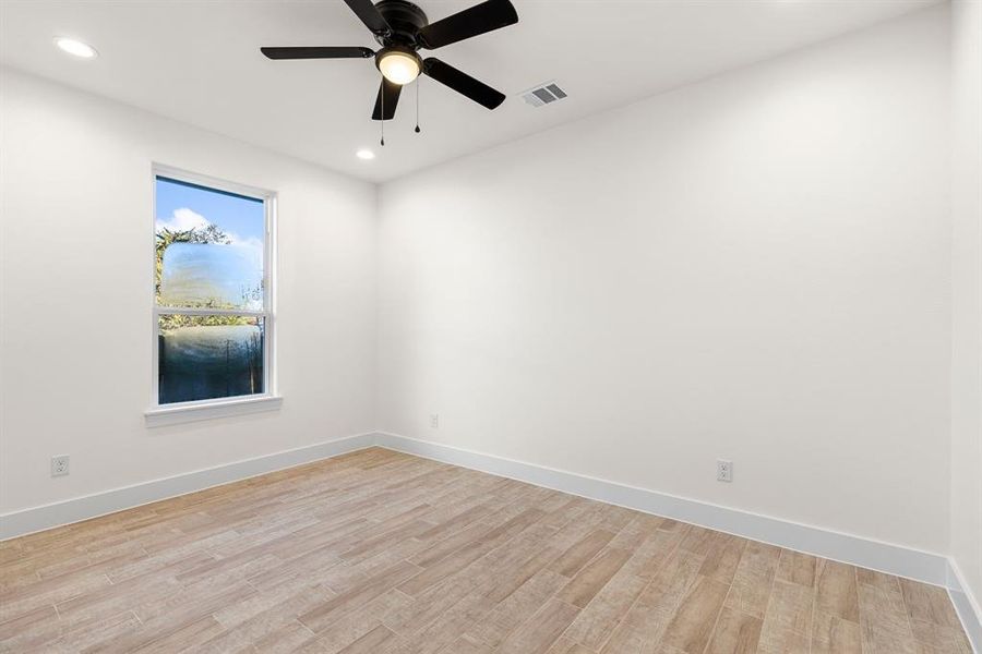 Unfurnished room with light wood-type flooring and ceiling fan