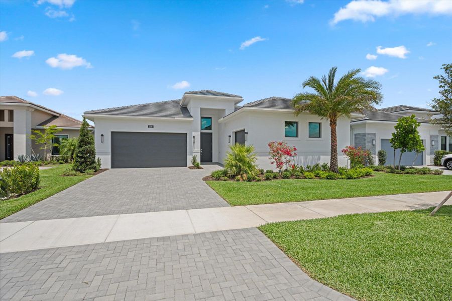 Front exterior of a new home in Cresswind Palm Beach at Westlake, Westlake, FL, highlighting curb appeal (Image 1). Front exterior of a new home in Cresswind Palm Beach at Westlake, Westlake, FL, highlighting curb appeal (Image 1).