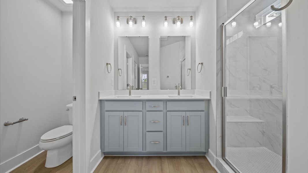 Exceptional en-suite with dual vanity and glass-enclosed tiled walk-in shower for superior everyday comfort Exceptional en-suite with dual vanity and glass-enclosed tiled walk-in shower for superior everyday comfort