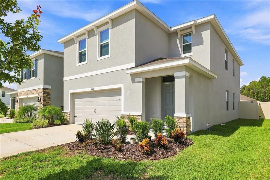 Front exterior of a new home in Deerbrook, Land O' Lakes, FL, highlighting curb appeal (Image 2). Front exterior of a new home in Deerbrook, Land O' Lakes, FL, highlighting curb appeal (Image 2).