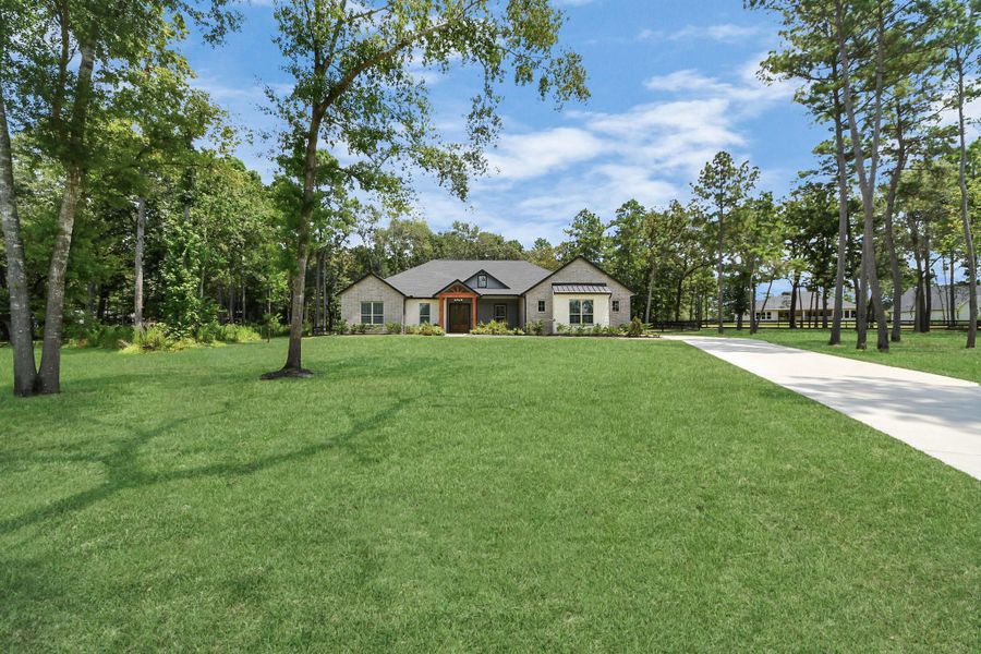 Front exterior of a new home in , Magnolia, TX, highlighting curb appeal (Image 21).