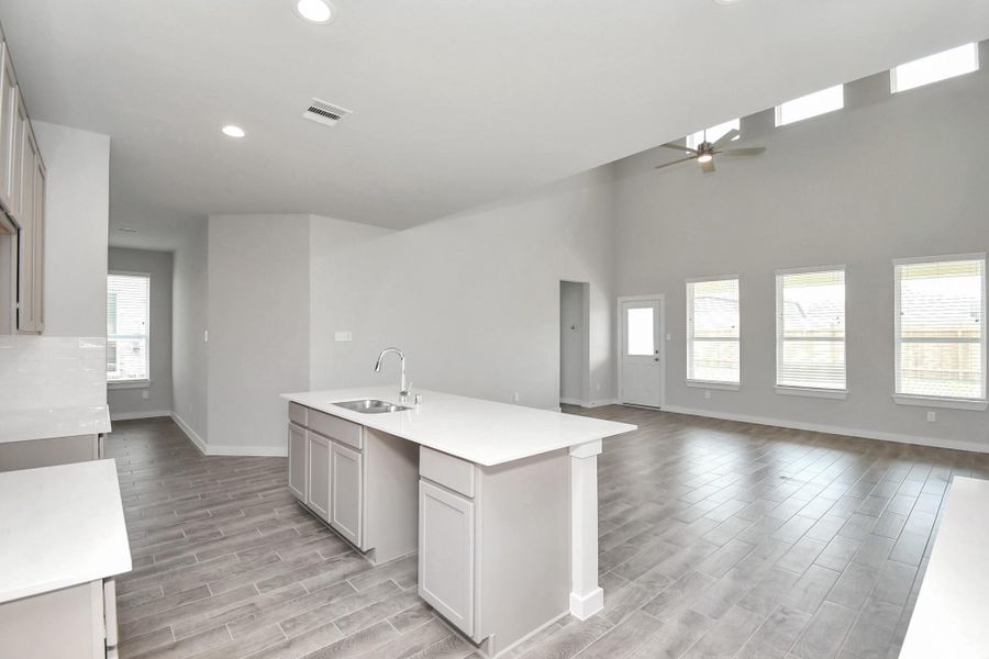 All of this overlooks your expansive family room, creating a perfect space for culinary delights and family gatherings. Sample photo of completed home with similar floor plan. Actual colors and selections may vary.