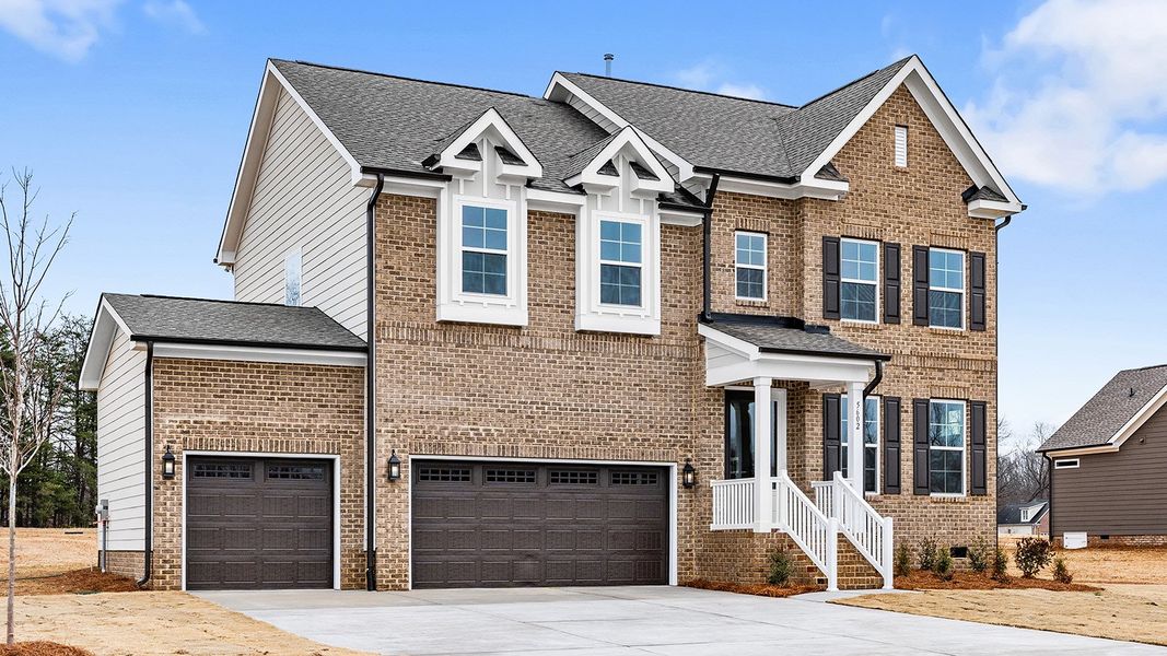 Front exterior of a new home in Lilah Grove, Summerfield, NC, highlighting curb appeal (Image 28). Front exterior of a new home in Lilah Grove, Summerfield, NC, highlighting curb appeal (Image 28).