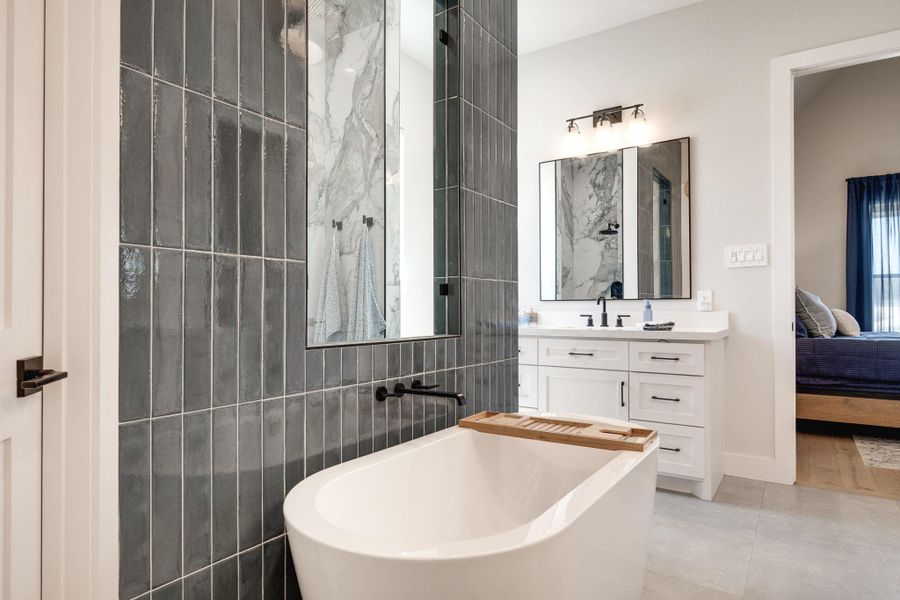 Bathroom with ensuite bath, vanity, a soaking tub, tile walls, and light tile patterned floors