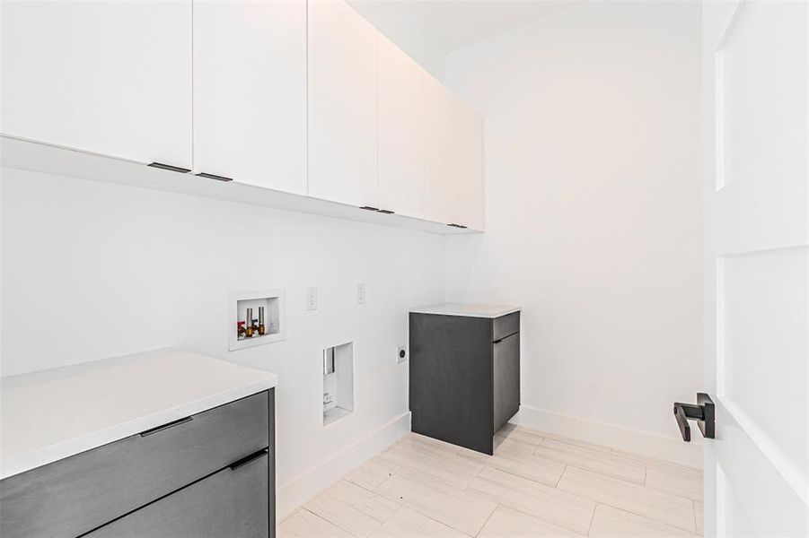 Washroom with hookup for a washing machine, hookup for an electric dryer, and cabinet space