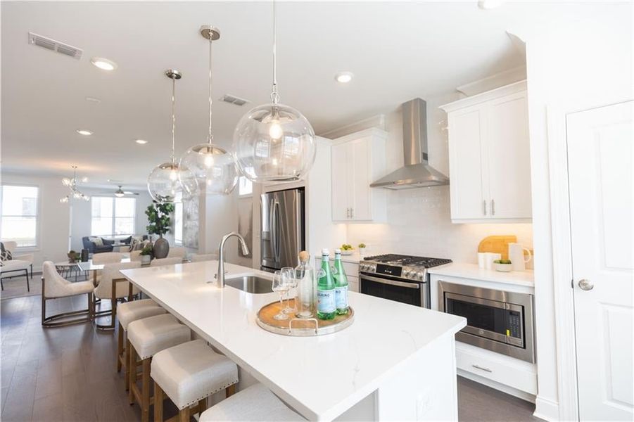 Large island anchors the kitchen. **Photos of model house and not of actual home - Photos for representation purposes only **