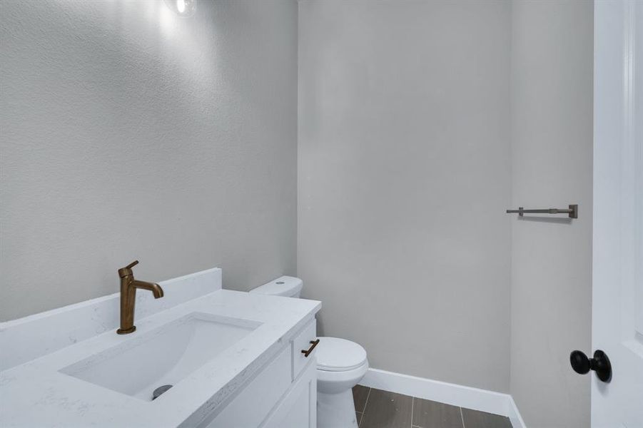 Bathroom with vanity, tile patterned flooring, and toilet