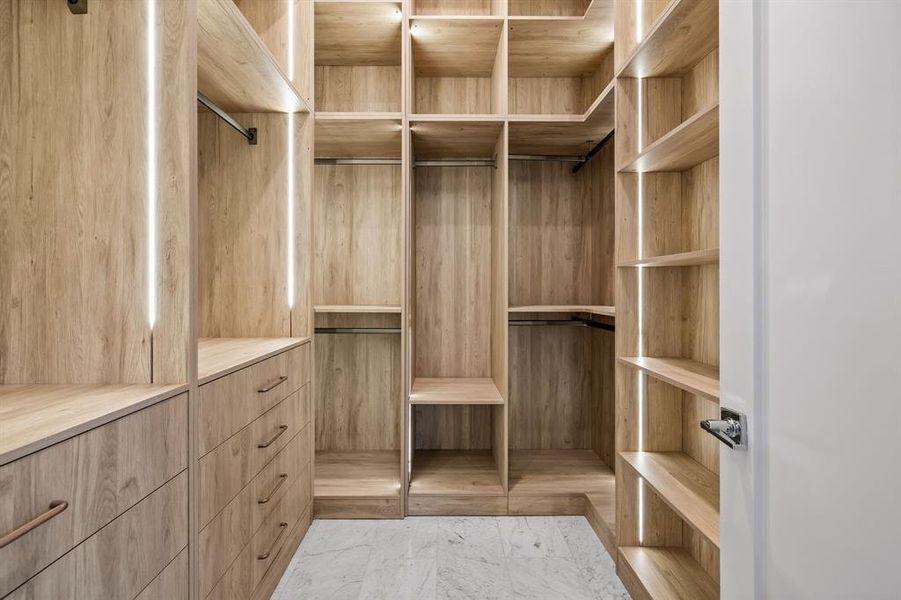 Walk in closet with marble finish floor