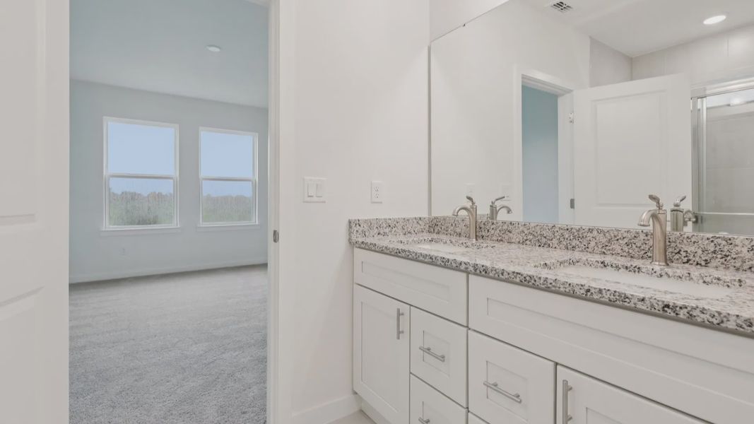 Primary Suite Bath with Dual Sinks in the Naples Floor Plan by DRB Homes Primary Suite Bath with Dual Sinks in the Naples Floor Plan by DRB Homes