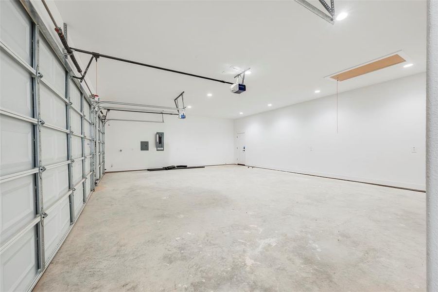 Garage with electric panel and recessed lighting