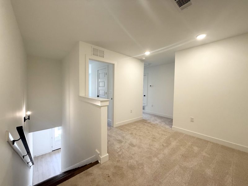 Unfurnished room featuring light colored carpet and recessed lighting
