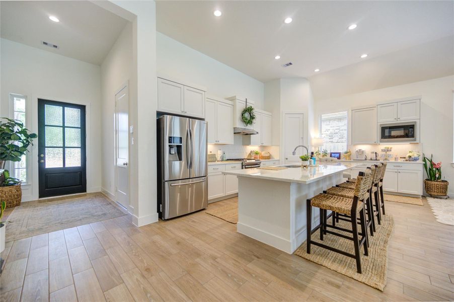 The kitchen opens to the surrounding living areas. The kitchen opens to the surrounding living areas.