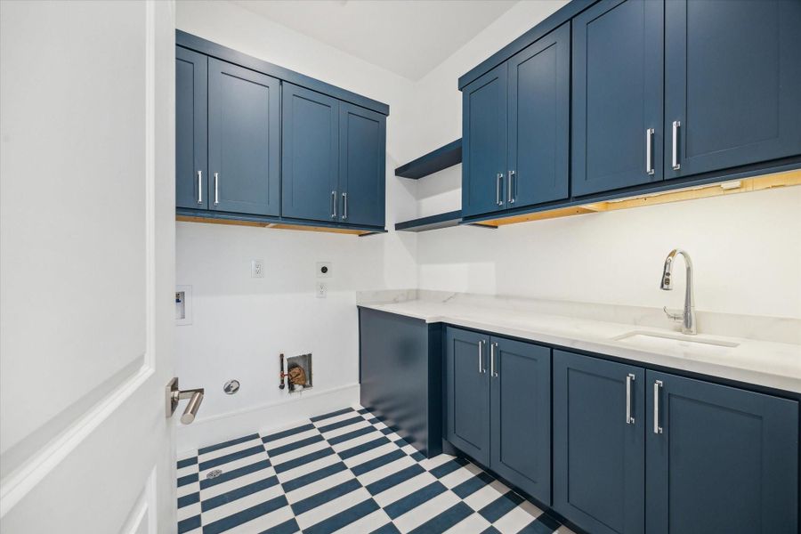 Utility room included on the second floor with plenty of built-in storage, along with Kohler Park Falls enameled cast iron undermount utility sink and Kohler Simplice compact faucet.