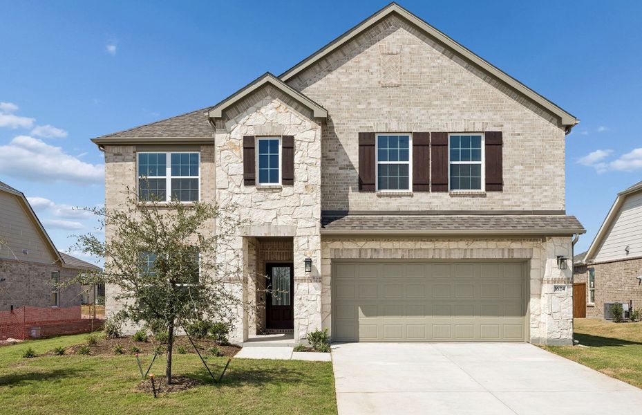 Front exterior of a new home in Anna Town Square, Anna, TX, highlighting curb appeal (Image 1). Front exterior of a new home in Anna Town Square, Anna, TX, highlighting curb appeal (Image 1).