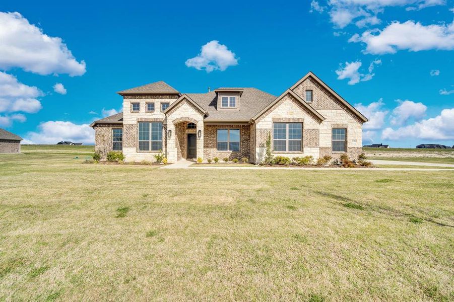 Front exterior of a new home in Levante, Waxahachie, TX, highlighting curb appeal (Image 18). Front exterior of a new home in Levante, Waxahachie, TX, highlighting curb appeal (Image 18).
